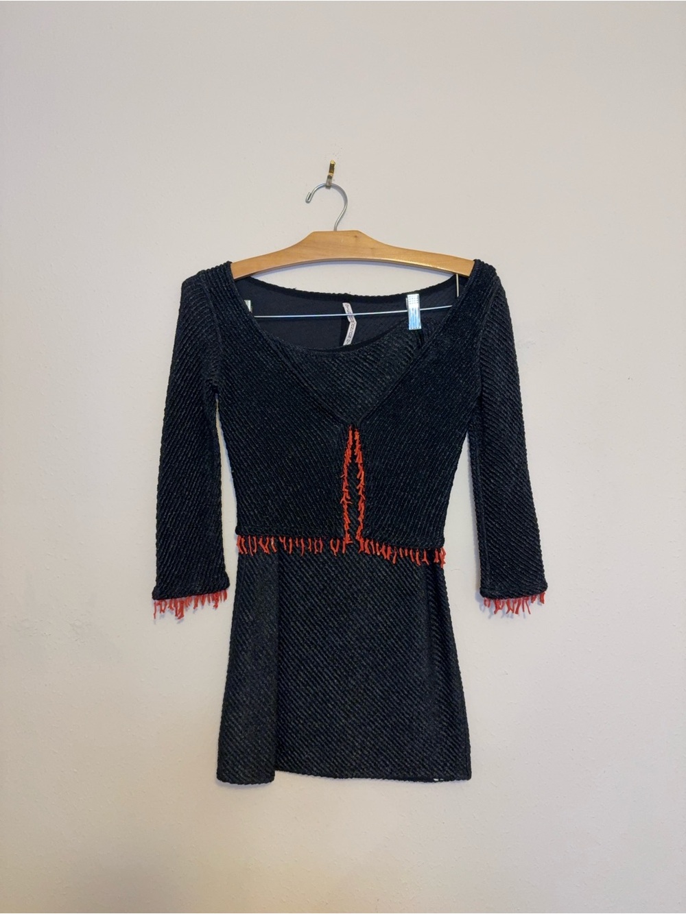 Black Long-Sleeve V-Neck topwith Red Fringe Trim and a black skirt